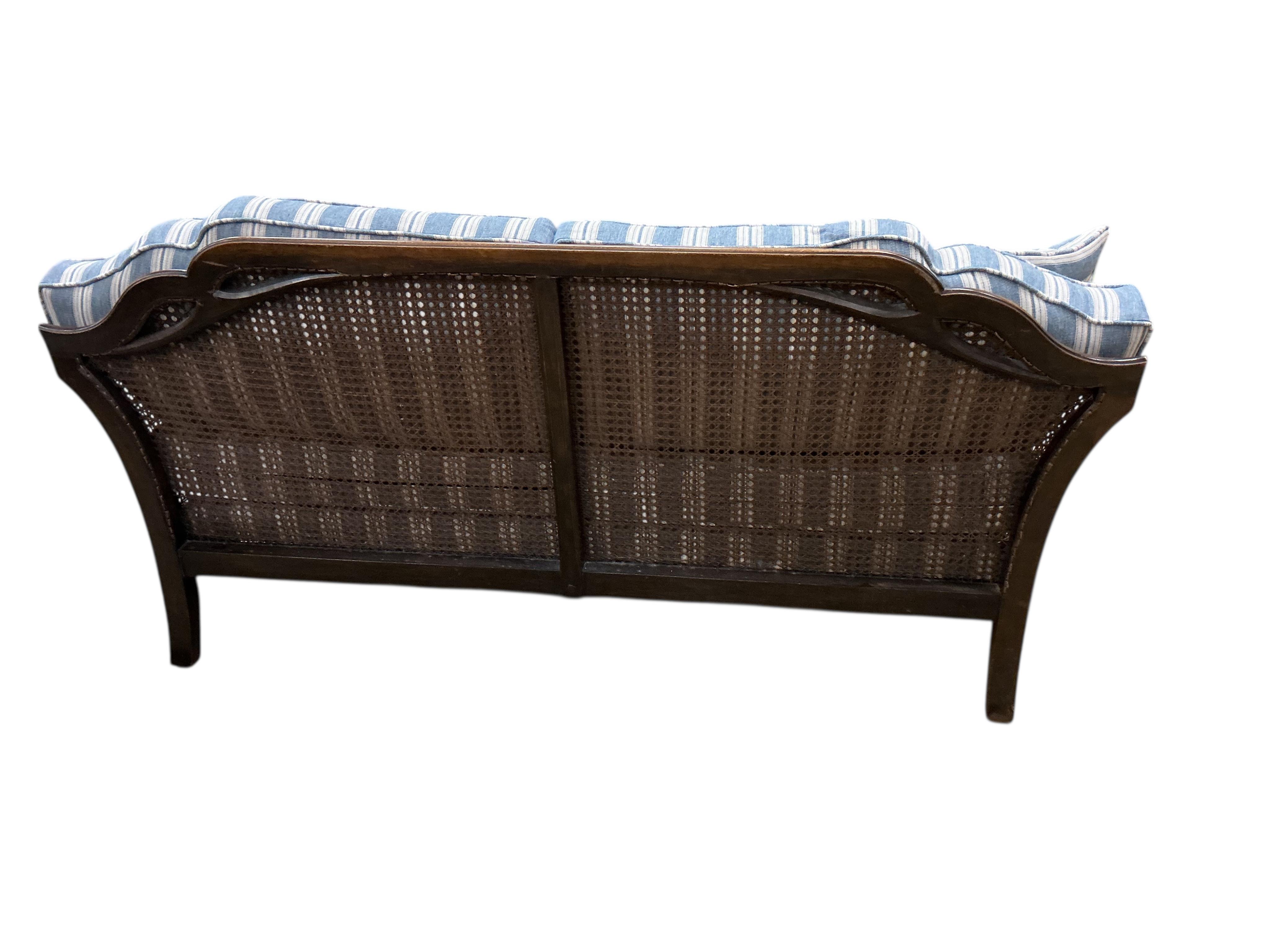 An early 20th century William & Mary style oak bergere settee, with loose cushion seat and back, width 172cm, depth 71cm, height 80cm